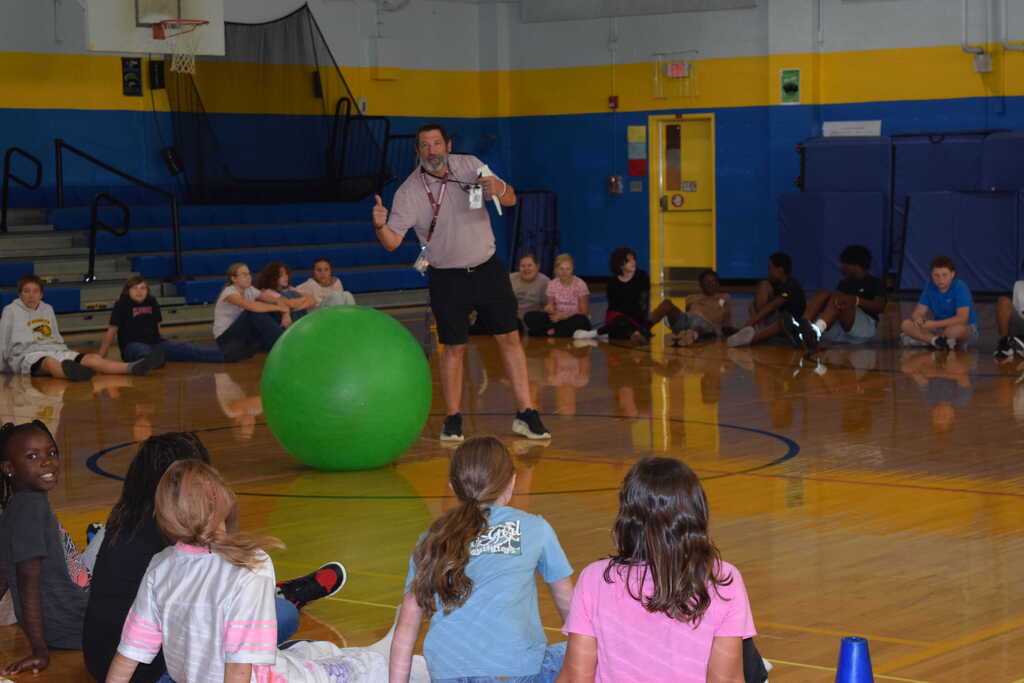 Coach and students playing incentive activity