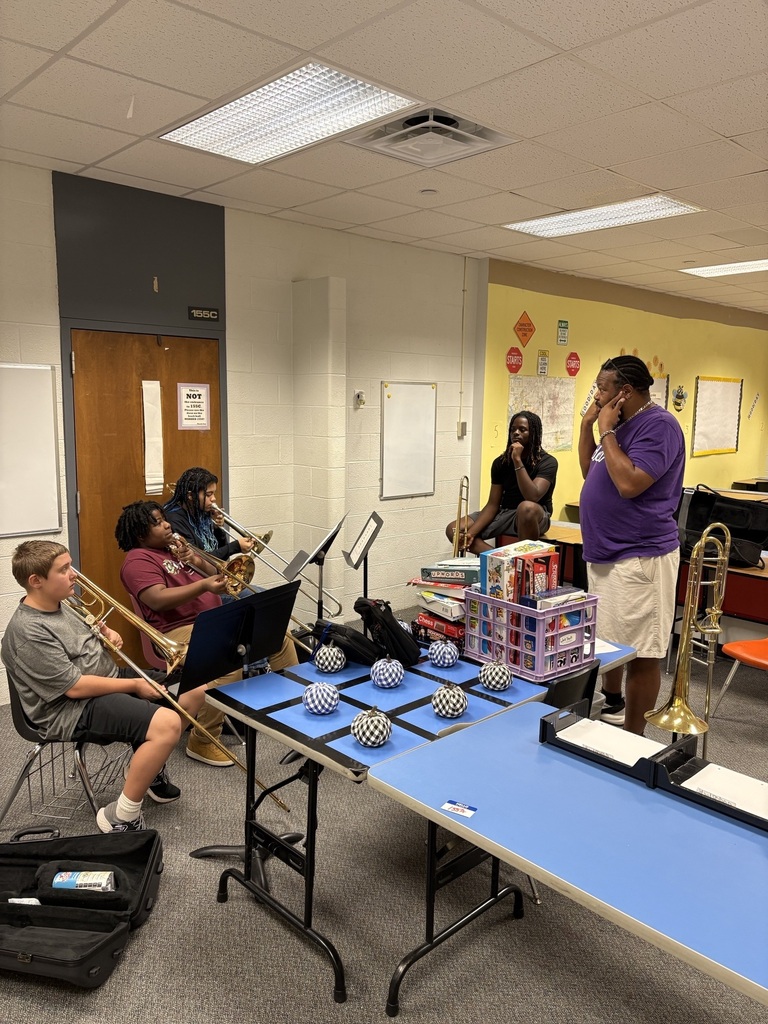 students playing trombones