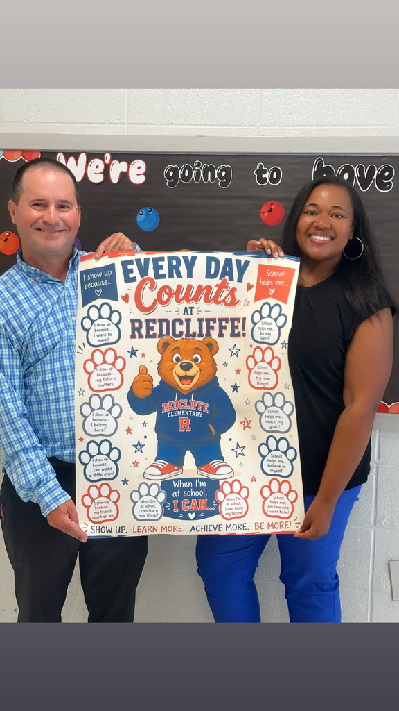 A man and woman hold up a poster with the words "Every Day Counts at Redcliffe" and a bear.