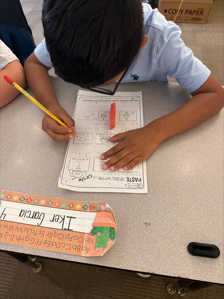 A student is practicing writing at their desk.