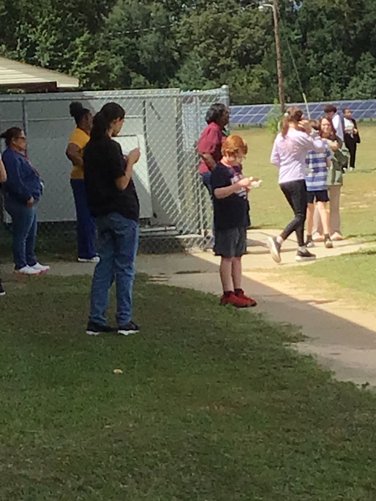 Scholars eating ice cream and playing outside.