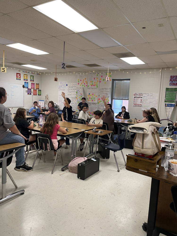 Student Council members interacting during a meeting .