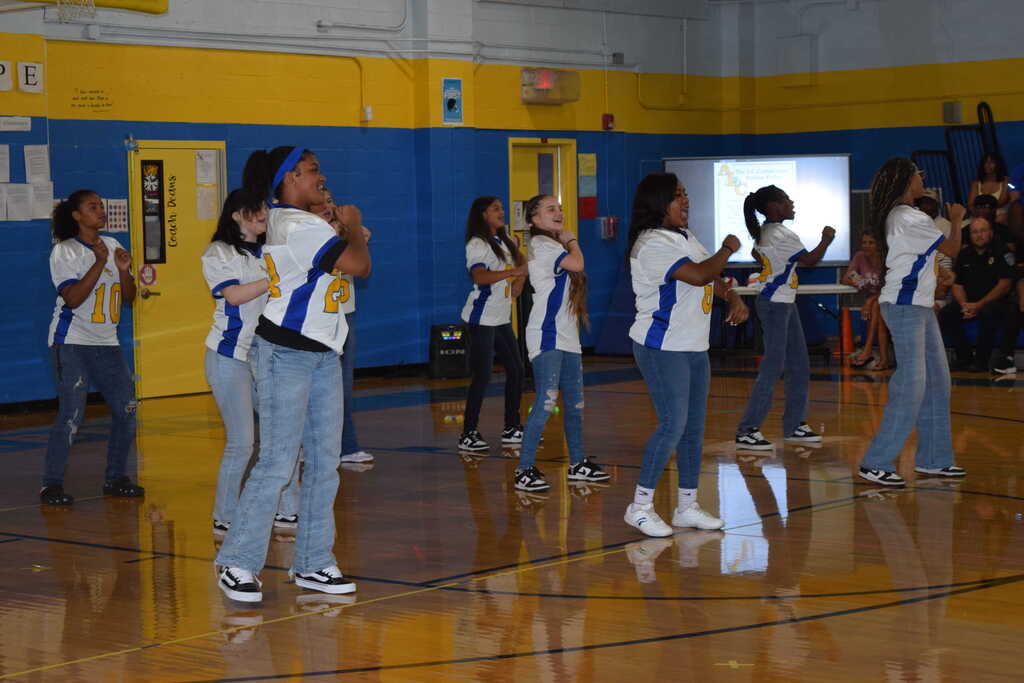 Cheerleaders cheering in gym