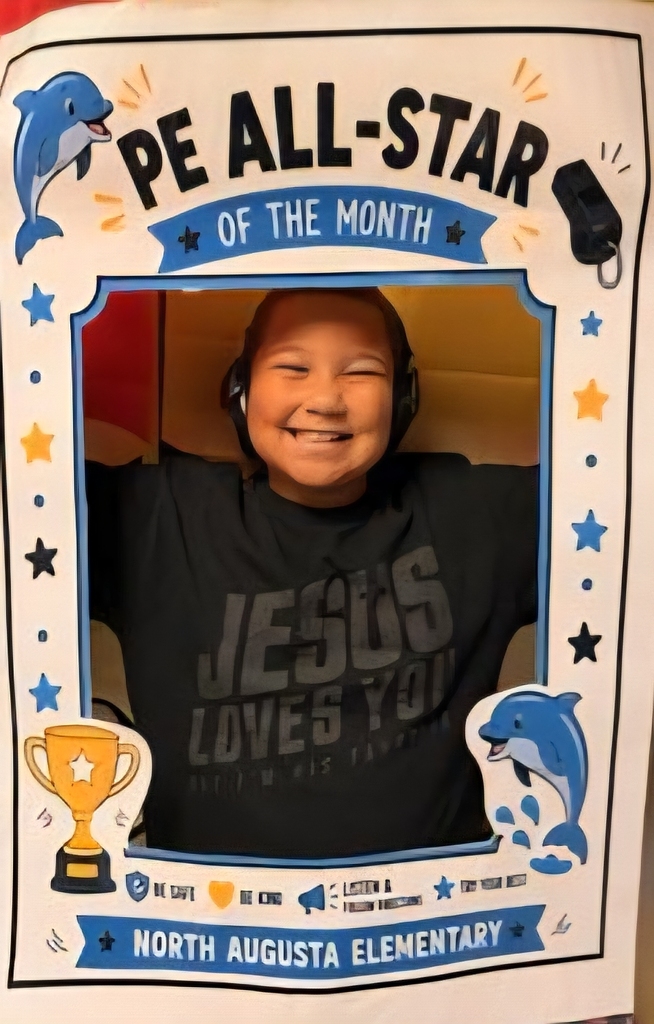 A smiling child wearing headphones. The photo is framed with stars and dolphins. Text reads "PE ALL-STAR OF THE MONTH" and "JESUS LOVES YOU."