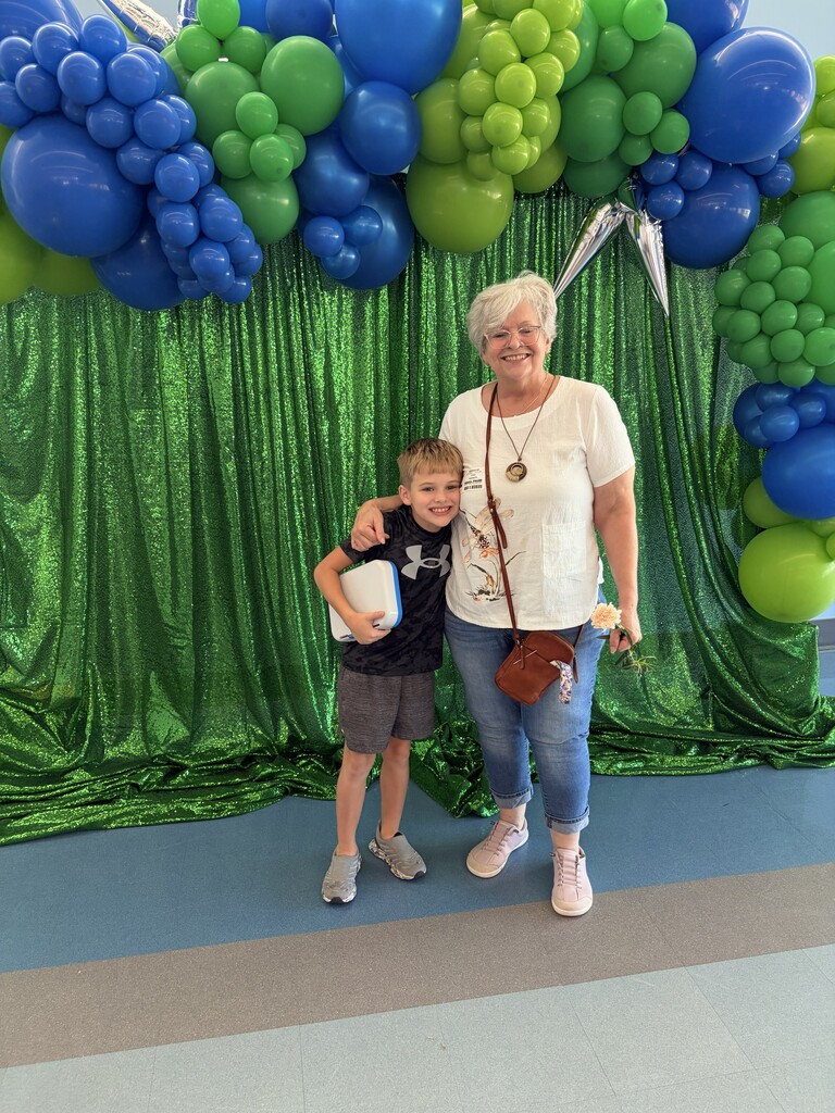 woman and young boy smiling at camera