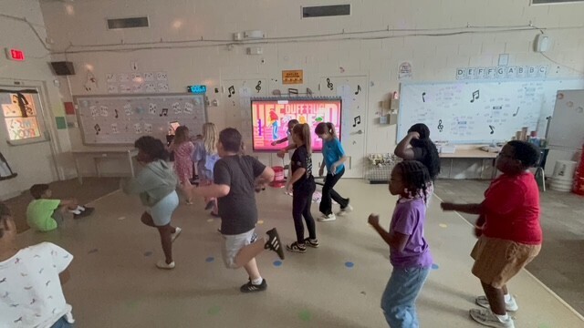 A class of students are dancing.