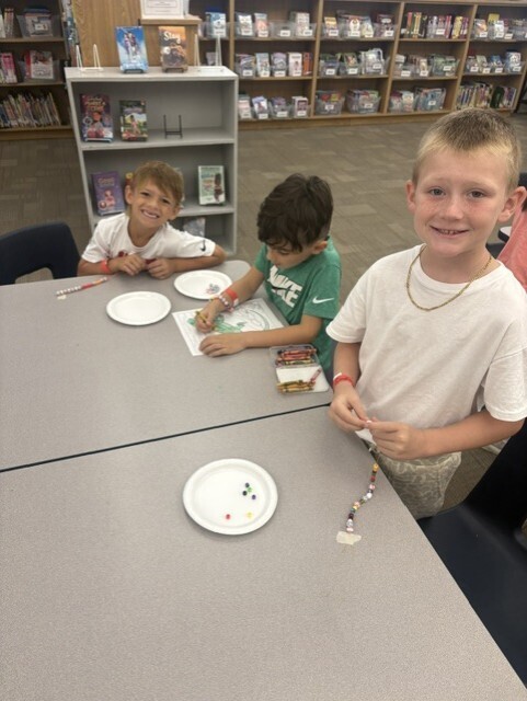 Three boys are working on crafts.