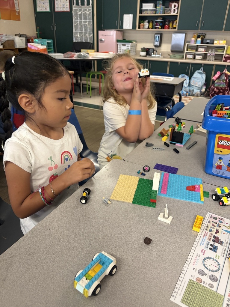 Two girls are building with Legos.