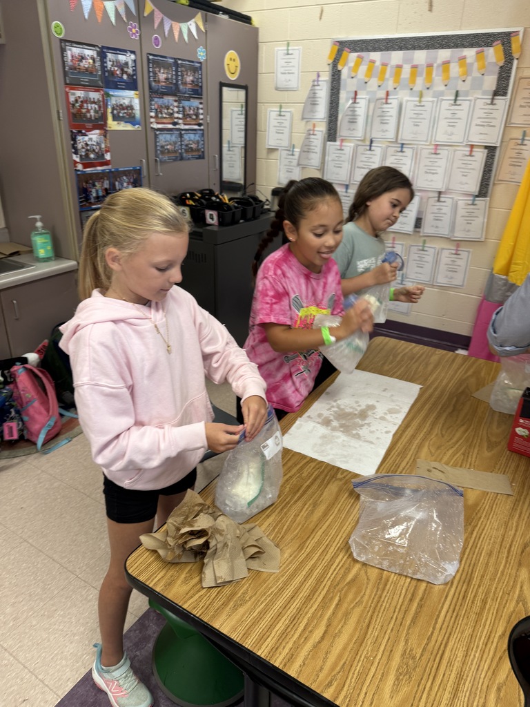 Three girls are working on a project.