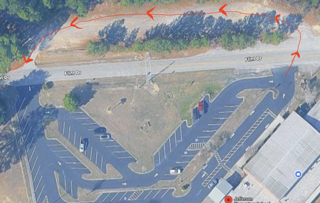 A picture of a school parking lot.