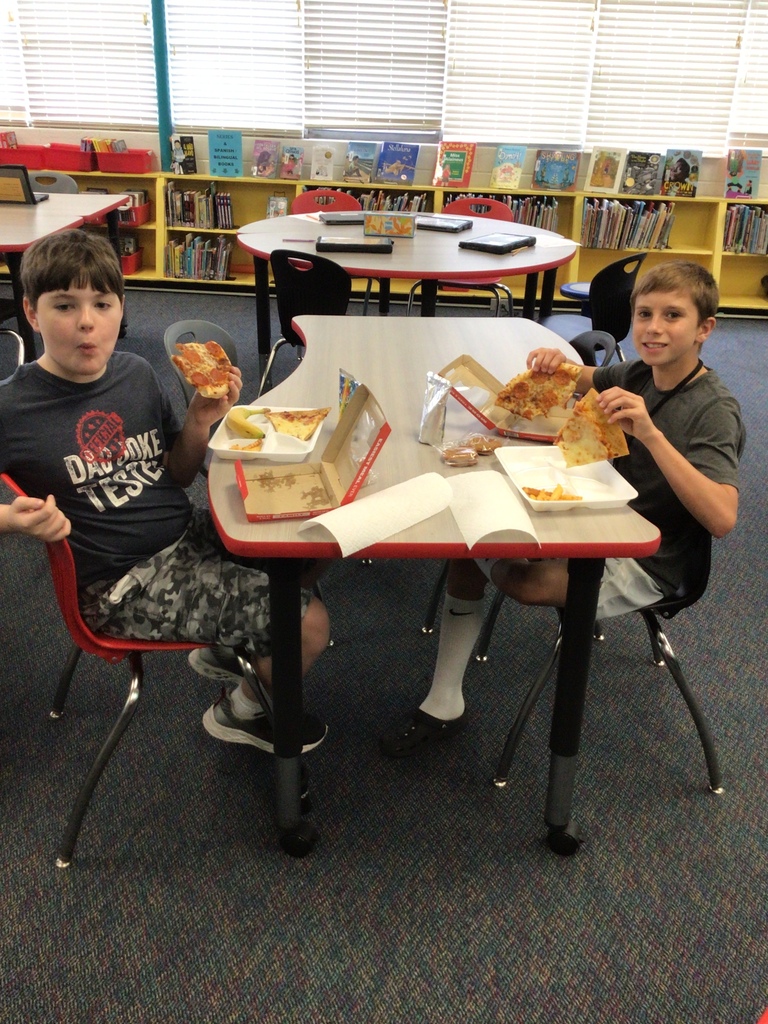 Two students eating lunch in the library.