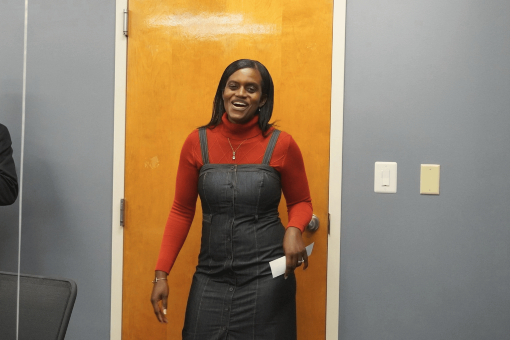 HR employee smiling while being surprised.