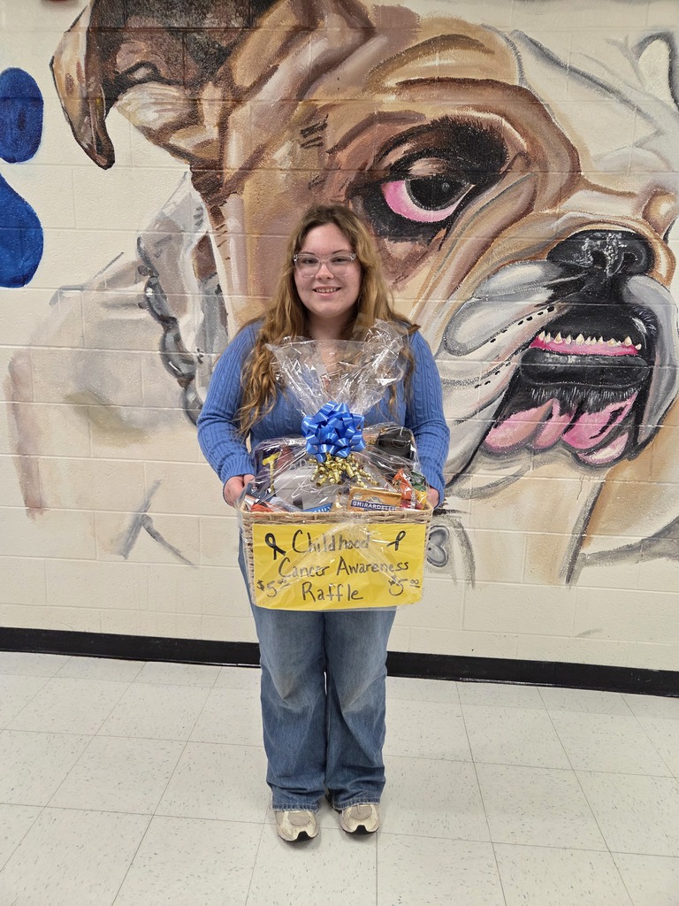 A student holding a gift basket full of goodies