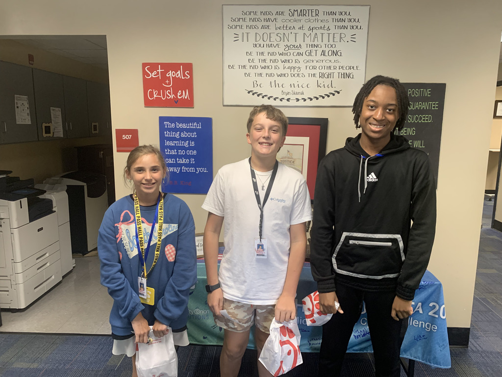 3 students holding chick fil a