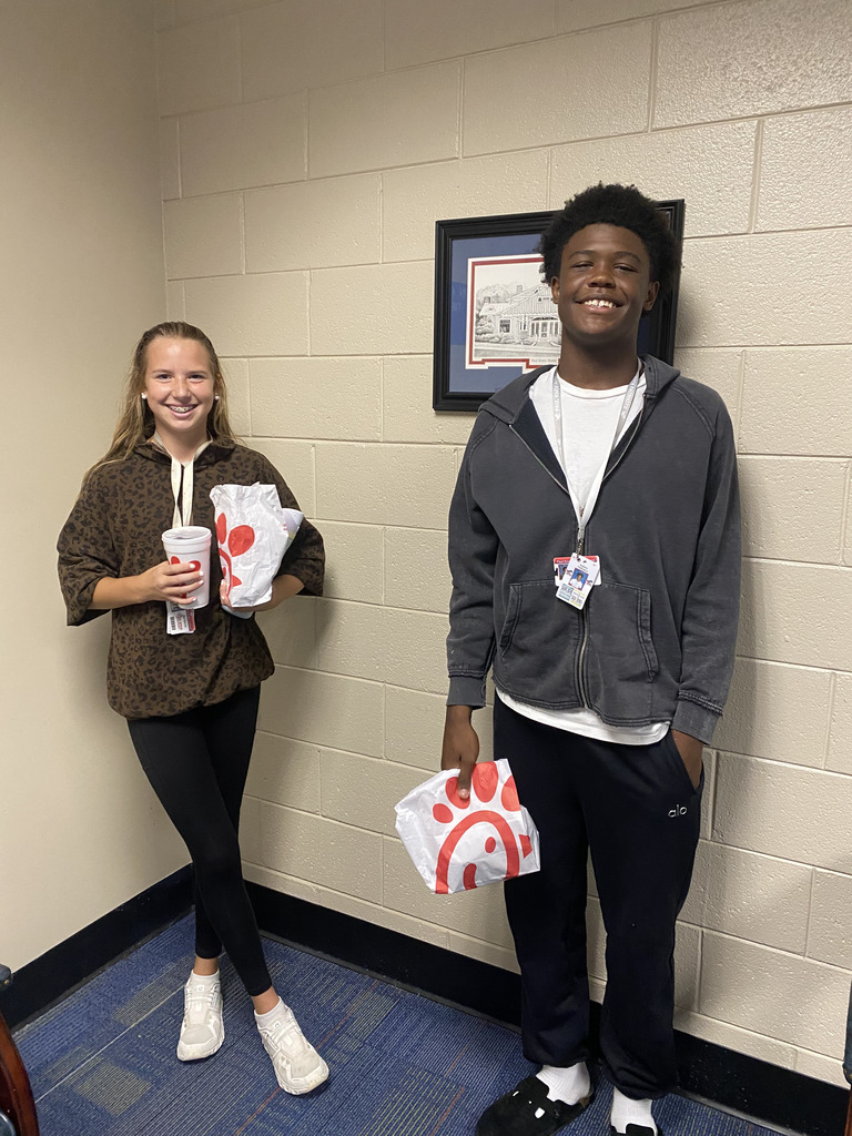 2 students holding chick fil a