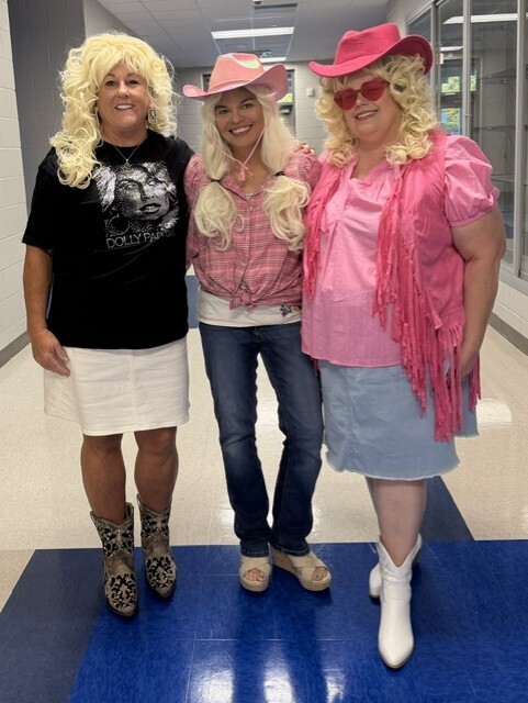 Teachers pose for Dolly dress up day