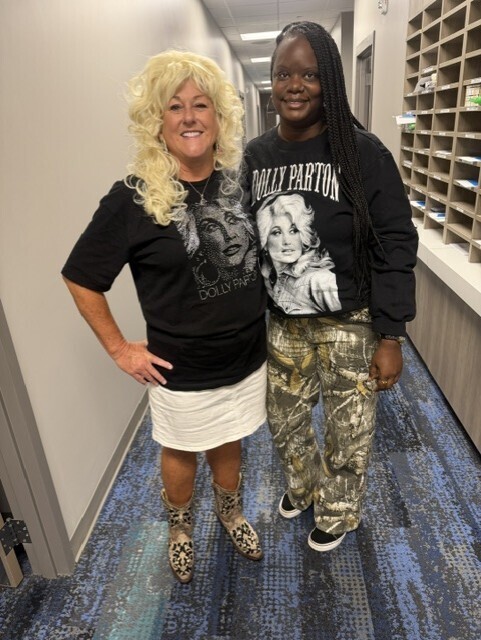 Teachers pose for Dolly dress up day