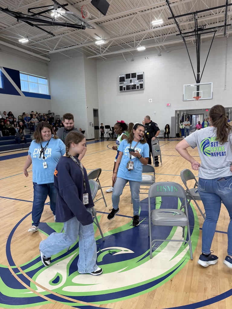 Students and teachers playing musical chairs