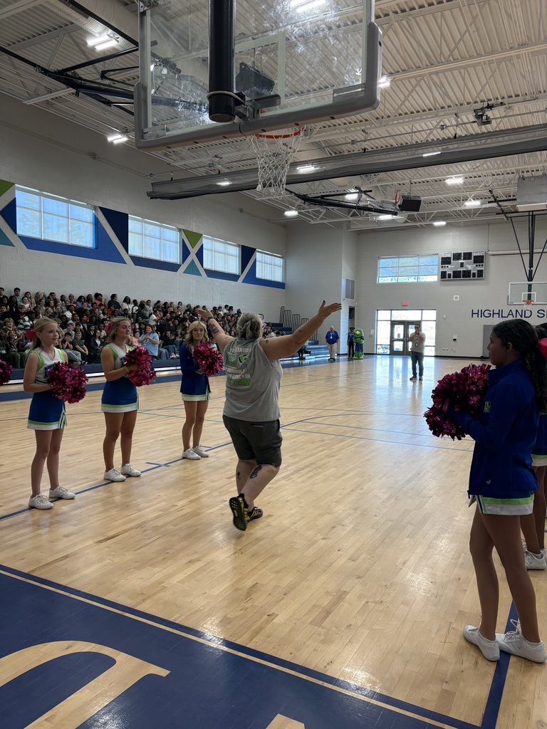 School faculty showing off tattoos at pep rally