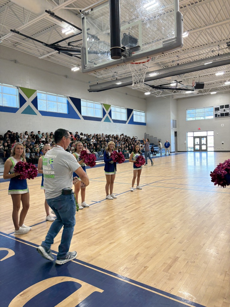 School faculty showing off tattoos at pep rally