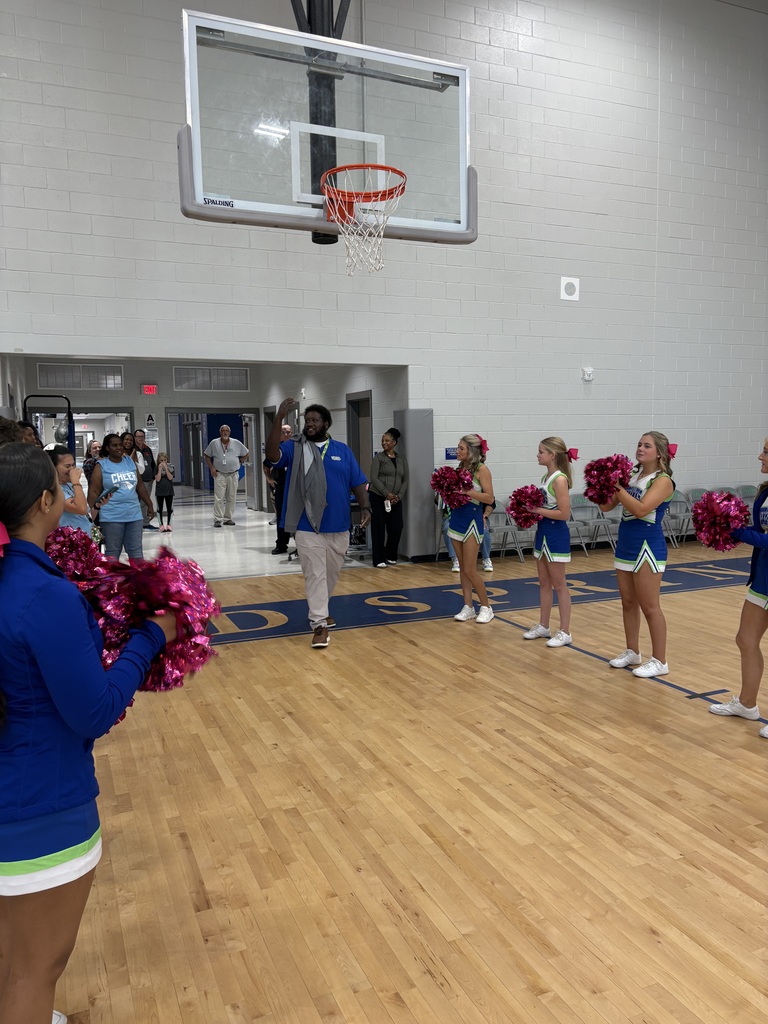 School faculty showing off tattoos at pep rally
