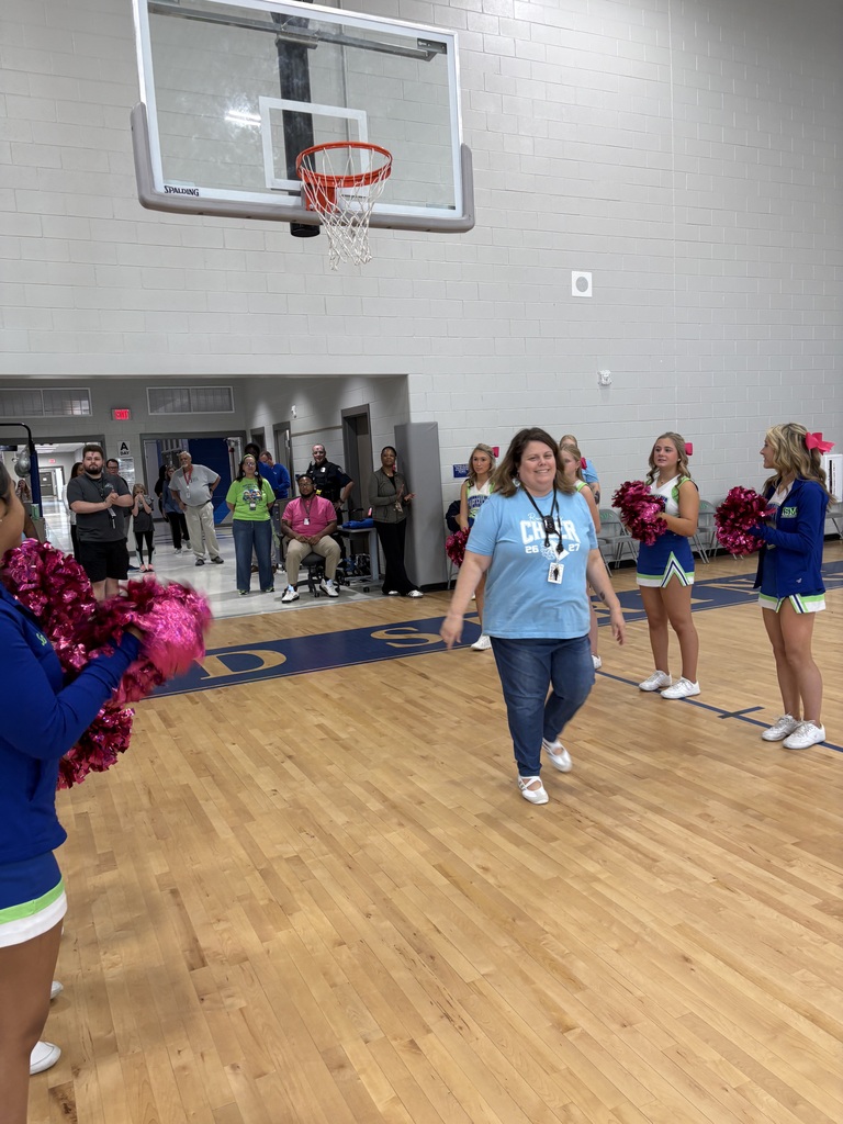 School faculty showing off tattoos at pep rally