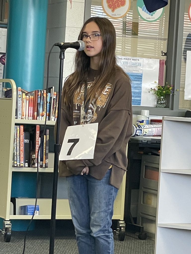 Arianna spelling a word during the spelling bee.