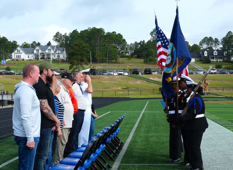 The NJROTC students walk towards district leadership.