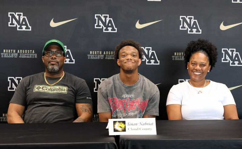 Player with family at signing. 