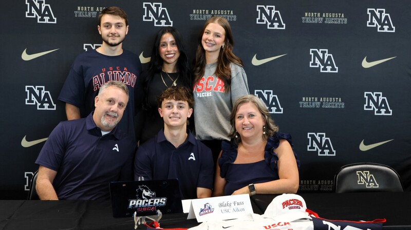 Player with family at signing. 