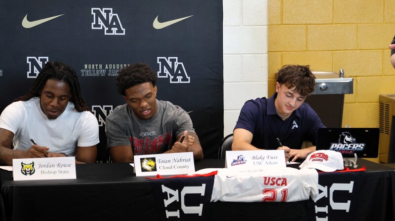Player with family at signing. 