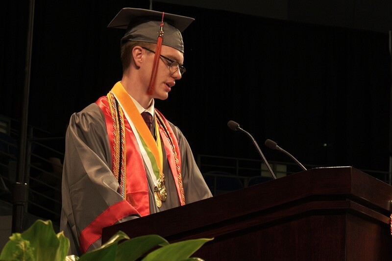 Valedictorian Elias Ezekial James speaking at the podium.