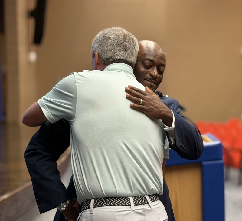 Dr. Corey Murphy hugs David Revelle.