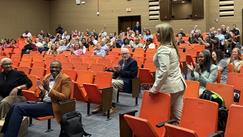 A principal goes to accept her award.