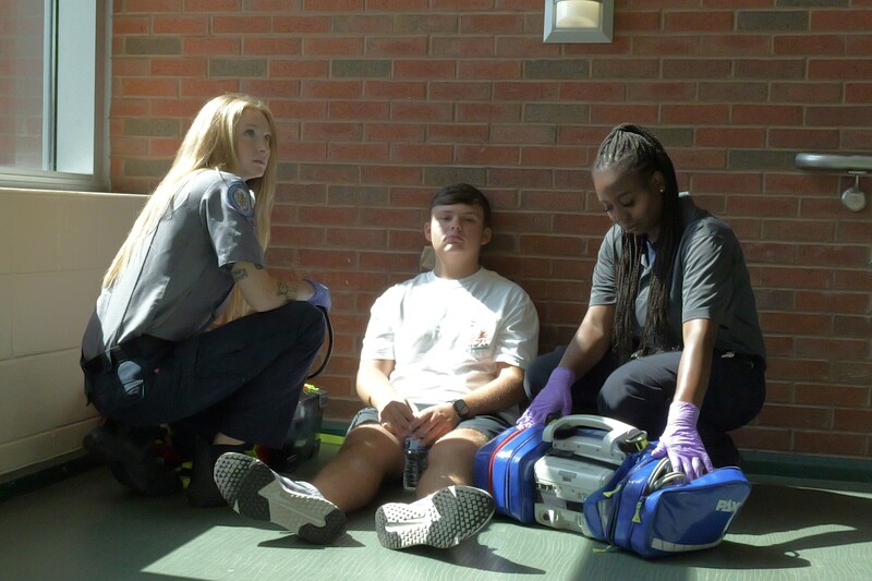 Student getting assistance from EMS.