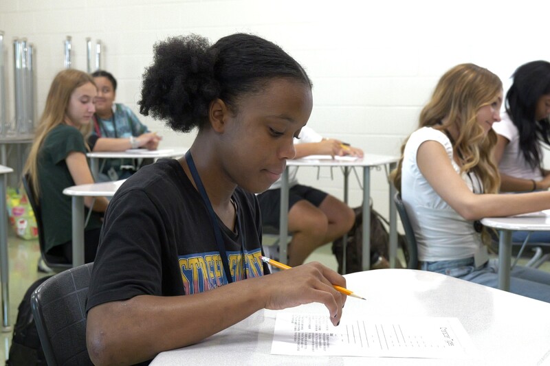 Student filming a scene where shes doing work at her desk.