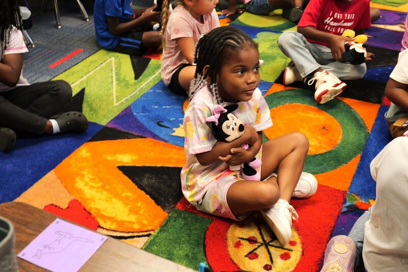 4k Student hugging Minnie Mouse toy.
