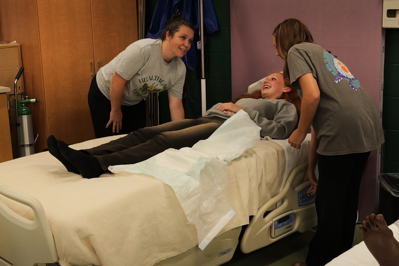 Kristy Ghrist and a student demonstrate health science currriculum.