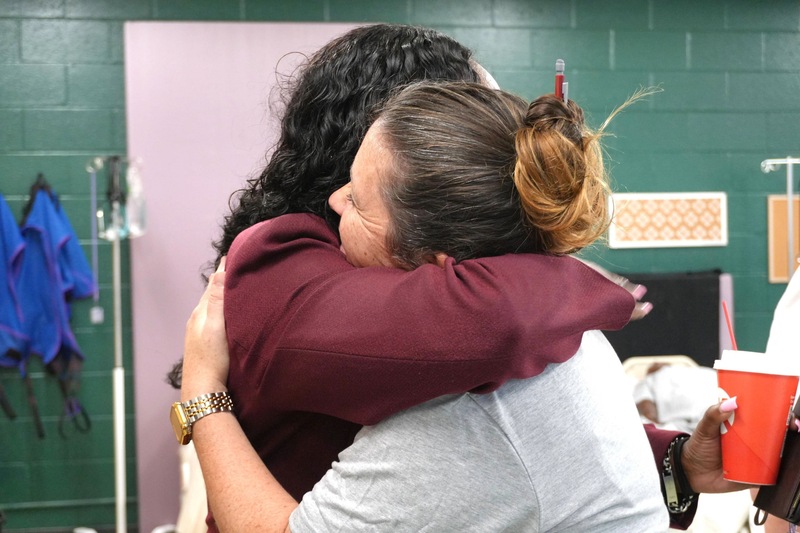 Kristy Ghrist hugs another ACPSD employee.