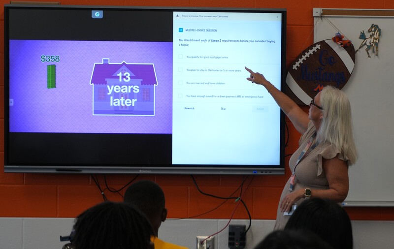 Ginger Proctor points to her SmartBoard.