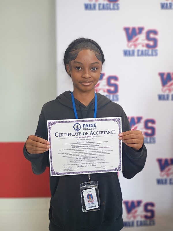 Adriana Bell holding her acceptance certificate