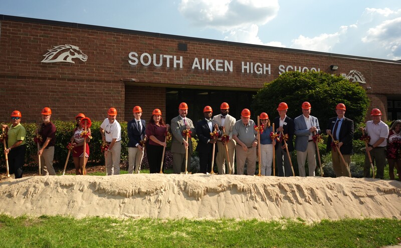 Community and District leaders hold shovels to mark milestone groundbreaking at South Aiken High School.