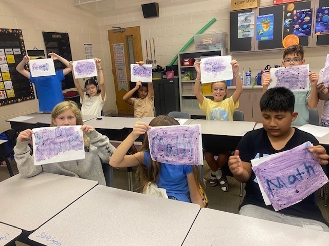  their sheets of paper to show their hidden messages.