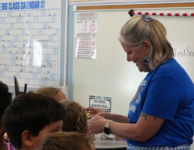 Cassie Remson shows Golden Apple to her students.
