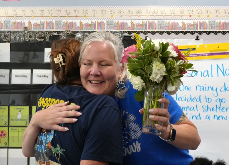 Cassie Remson smiles with flowers in her hand.