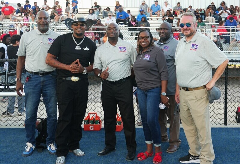 District leadership pose for a photo at J.O. Brown stadium.