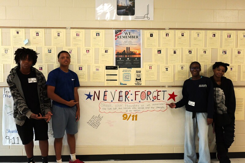 Students pose in front of 9/11 memorial wall at Aiken High.
