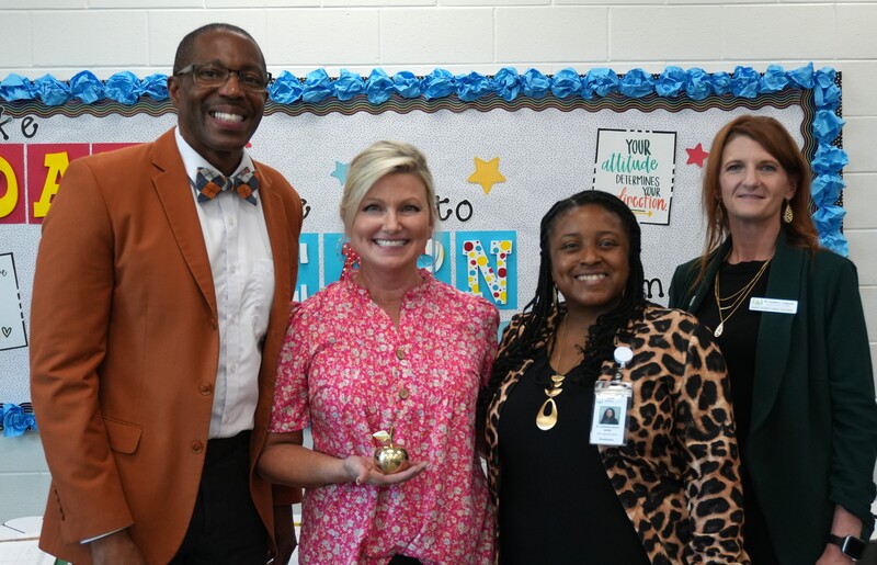 Amy Hadden smiles alongside District Leadership.