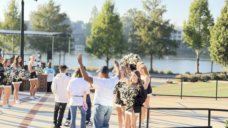 North Augusta cheerleaders welcome Roll and Stroll participants.