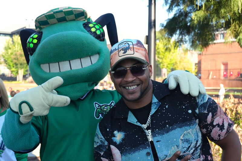 Augusta GreenJackets mascot and Douglas Furtick pose for a photo.